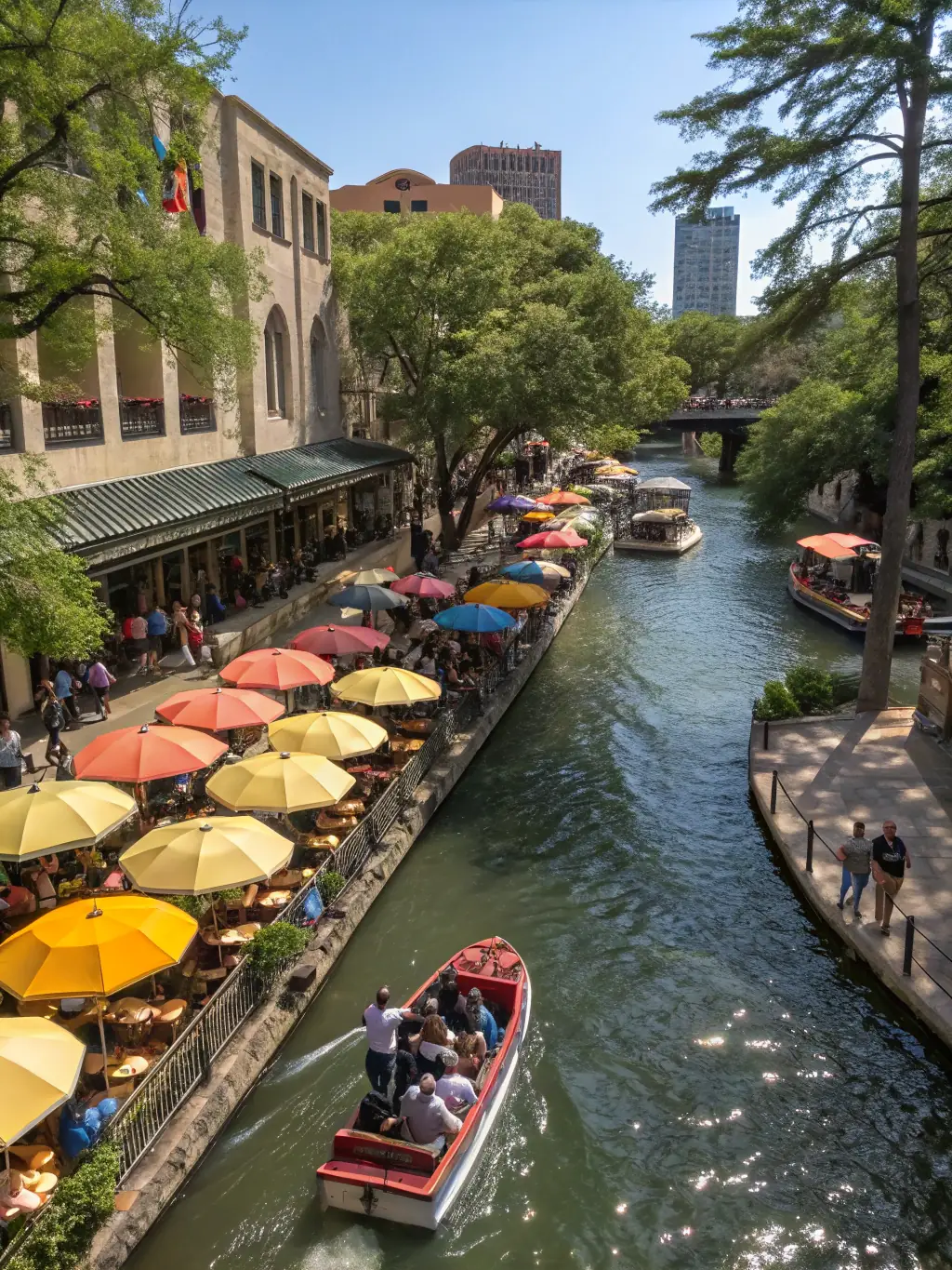 A picturesque scene of the San Antonio River Walk as it passes through the King William neighborhood, highlighting the lush greenery and historic bridges.